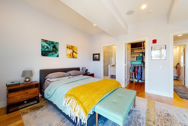 488 Dorchester Ave Unit 4H, Boston, MA 02127 - bedroom featuring light wood-type flooring, a walk in closet, a closet, baseboards, and recessed lighting