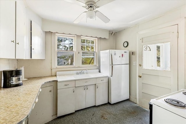 kitchen with white cabinetry, sink, white appliances, and ceiling fan