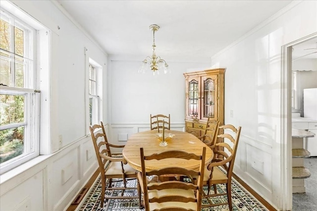 dining room featuring an inviting chandelier and ornamental molding