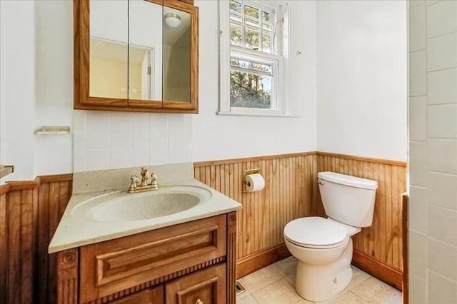 bathroom featuring toilet, vanity, and tile patterned floors