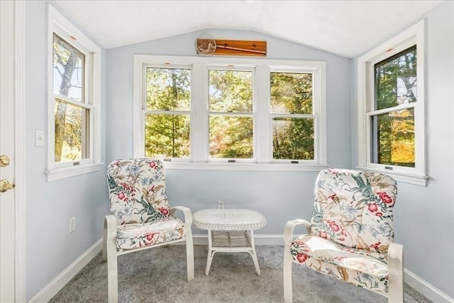 sunroom featuring lofted ceiling and a healthy amount of sunlight