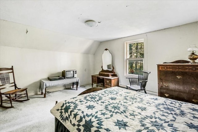 carpeted bedroom with vaulted ceiling