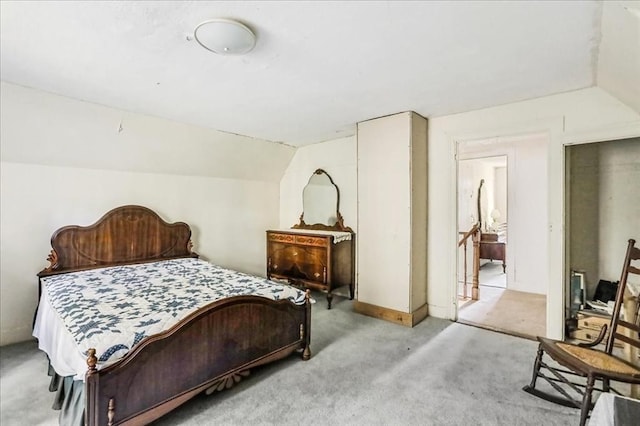 carpeted bedroom featuring vaulted ceiling