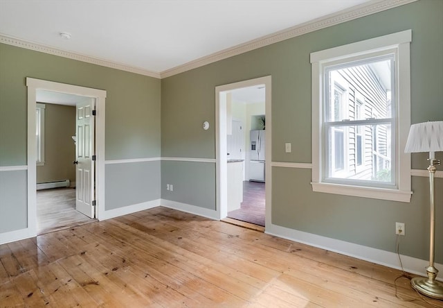 15 Reed St Unit 2, West Boylston, MA 01583 - spare room featuring baseboard heating, ornamental molding, hardwood / wood-style floors, baseboards, and a smoke detector