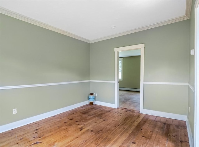 15 Reed St Unit 2, West Boylston, MA 01583 - empty room with crown molding, hardwood / wood-style floors, baseboards, and a baseboard heating unit