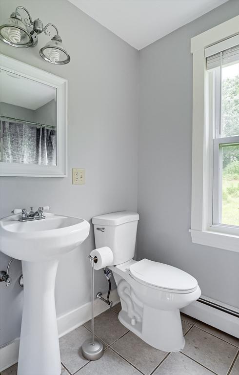 15 Reed St Unit 2, West Boylston, MA 01583 - bathroom featuring a baseboard radiator, toilet, tile patterned flooring, a sink, and baseboards