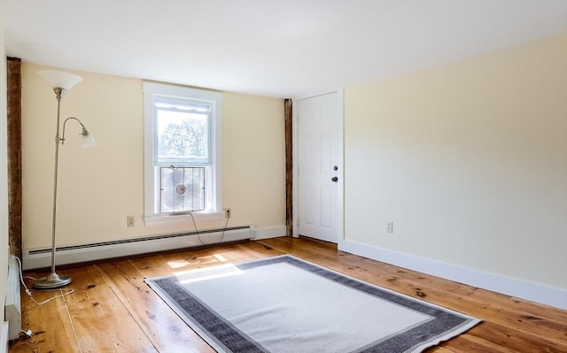 15 Reed St Unit 2, West Boylston, MA 01583 - exercise area with a baseboard heating unit, hardwood / wood-style floors, and baseboards