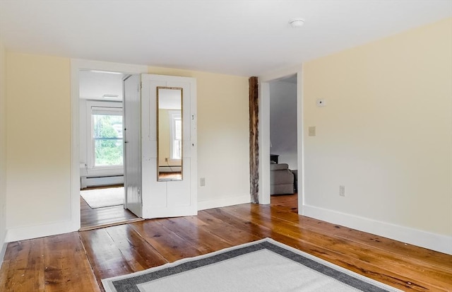 15 Reed St Unit 2, West Boylston, MA 01583 - unfurnished room featuring a baseboard radiator, hardwood / wood-style floors, and baseboards