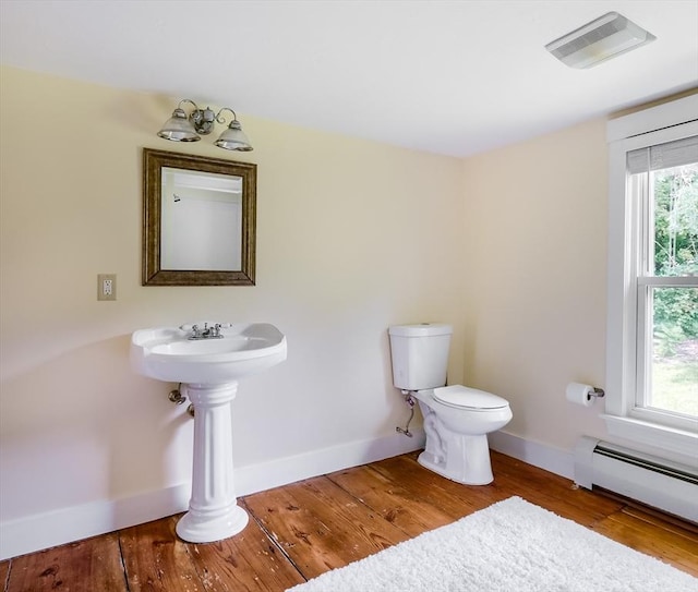 15 Reed St Unit 2, West Boylston, MA 01583 - half bathroom featuring baseboard heating, toilet, wood finished floors, and baseboards
