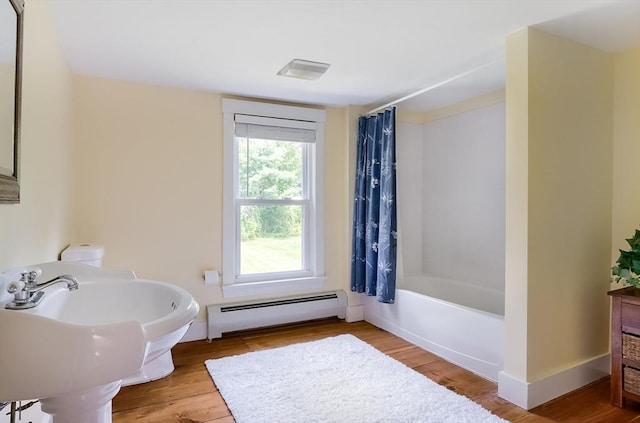 15 Reed St Unit 2, West Boylston, MA 01583 - full bath featuring a baseboard radiator, wood finished floors, shower / bathtub combination with curtain, and baseboards