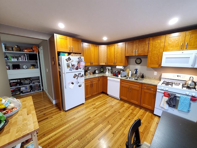 84-86R Cross St, Somerville, MA 02145 - kitchen with white appliances, light wood-type flooring, brown cabinets, and recessed lighting