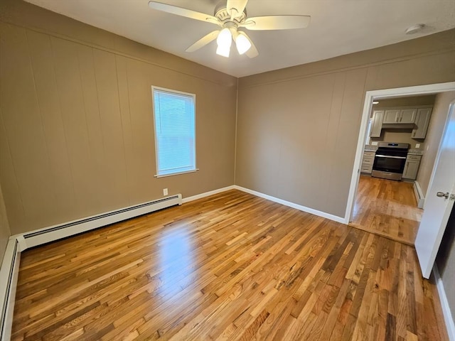 84-86R Cross St, Somerville, MA 02145 - unfurnished room featuring light wood finished floors, a ceiling fan, a smoke detector, a decorative wall, and a baseboard radiator