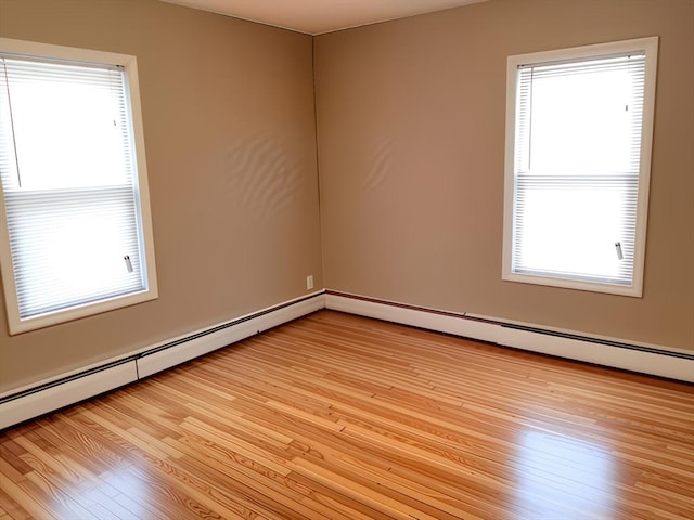 84-86R Cross St, Somerville, MA 02145 - unfurnished room featuring light wood-style flooring and a baseboard radiator