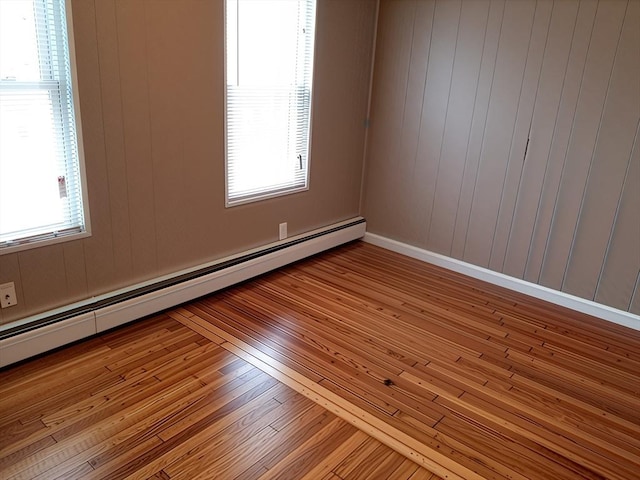 84-86R Cross St, Somerville, MA 02145 - unfurnished room with a baseboard heating unit, wood-type flooring, and healthy amount of natural light