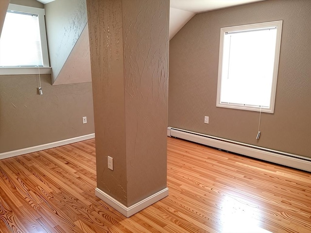 84-86R Cross St, Somerville, MA 02145 - bonus room with a baseboard heating unit, wood finished floors, lofted ceiling, and baseboards