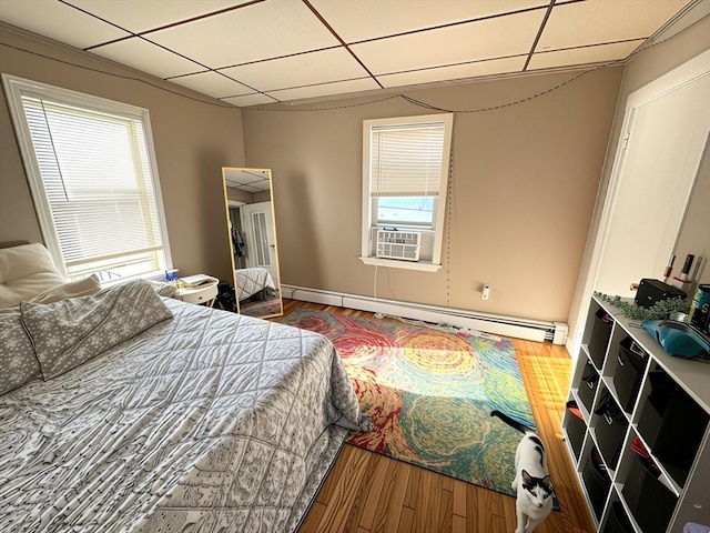 84-86R Cross St, Somerville, MA 02145 - bedroom with a paneled ceiling, a baseboard heating unit, wood finished floors, and cooling unit