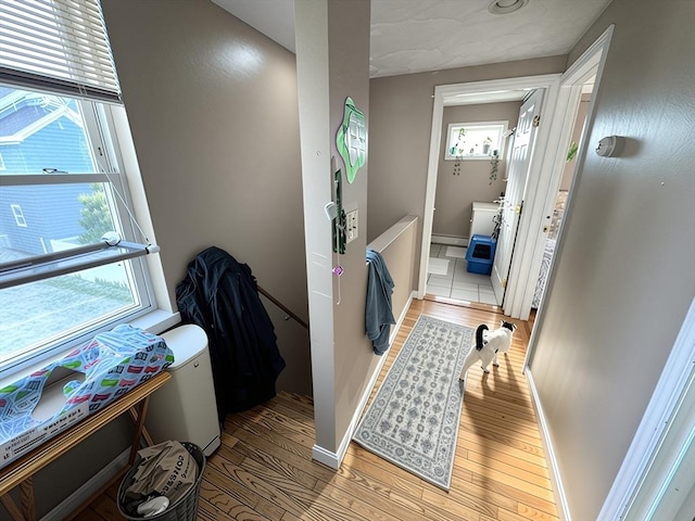 84-86R Cross St, Somerville, MA 02145 - corridor with wood finished floors, baseboards, and a baseboard radiator