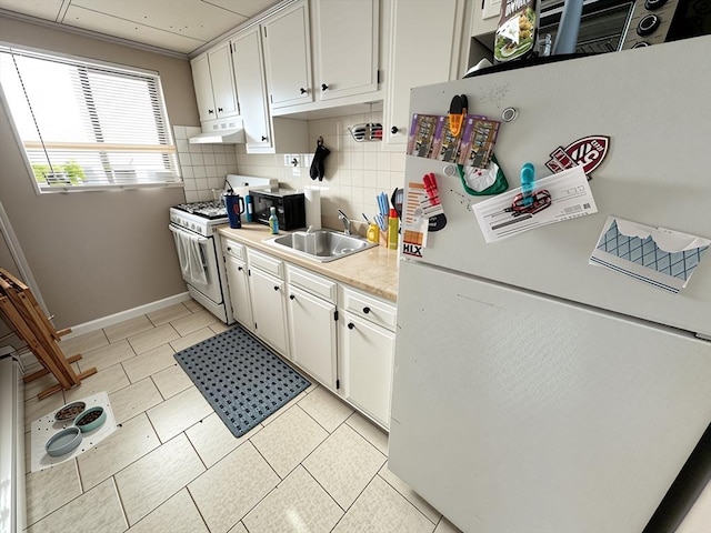 84-86R Cross St, Somerville, MA 02145 - kitchen featuring white appliances, a sink, under cabinet range hood, light countertops, and tasteful backsplash