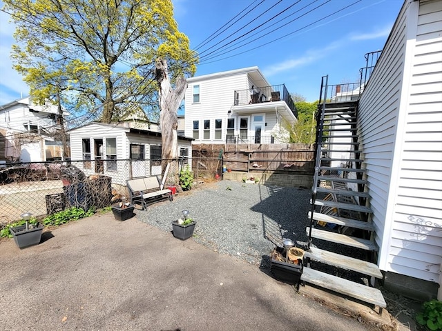 84-86R Cross St, Somerville, MA 02145 - back of property with stairs, a fenced backyard, and a patio area