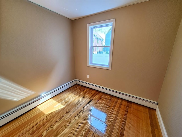 84-86R Cross St, Somerville, MA 02145 - unfurnished room featuring wood finished floors, baseboards, and a baseboard radiator