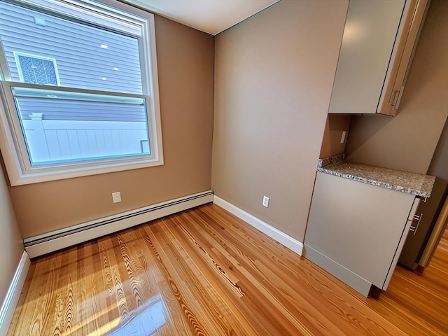 84-86R Cross St, Somerville, MA 02145 - spare room featuring a baseboard heating unit, light wood-style floors, and baseboards