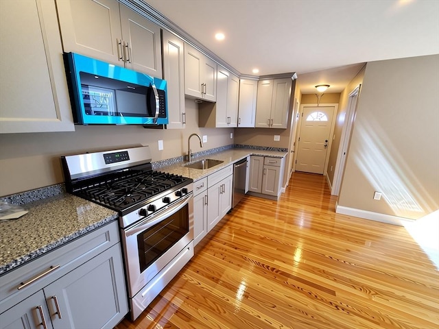 84-86R Cross St, Somerville, MA 02145 - kitchen featuring appliances with stainless steel finishes, a sink, light wood-style flooring, gray cabinets, and recessed lighting