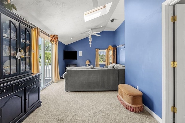 35 Pilgrim Dr, Norwood, MA 02062 - living room with light carpet, vaulted ceiling, a skylight, and ceiling fan