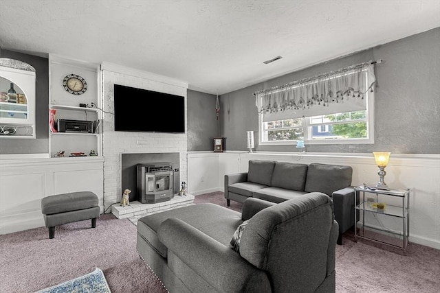 35 Pilgrim Dr, Norwood, MA 02062 - carpeted living area with a wood stove and baseboards
