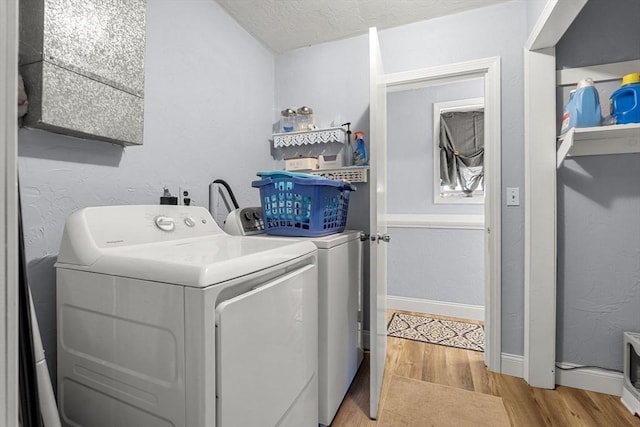 35 Pilgrim Dr, Norwood, MA 02062 - washroom featuring light wood-style flooring, a textured ceiling, a textured wall, and washing machine and clothes dryer