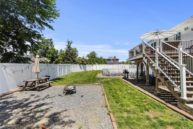 35 Pilgrim Dr, Norwood, MA 02062 - fenced backyard with an outdoor fire pit, stairs, a deck, and a patio area