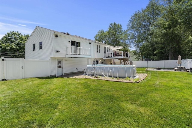 35 Pilgrim Dr, Norwood, MA 02062 - rear view of house with a fenced backyard and a balcony