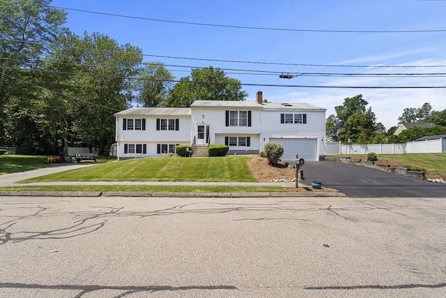 35 Pilgrim Dr, Norwood, MA 02062 - bi-level home featuring driveway, a garage, and a chimney