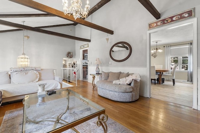 35 Pilgrim Dr, Norwood, MA 02062 - living room featuring a chandelier, beamed ceiling, a wainscoted wall, wood finished floors, and high vaulted ceiling