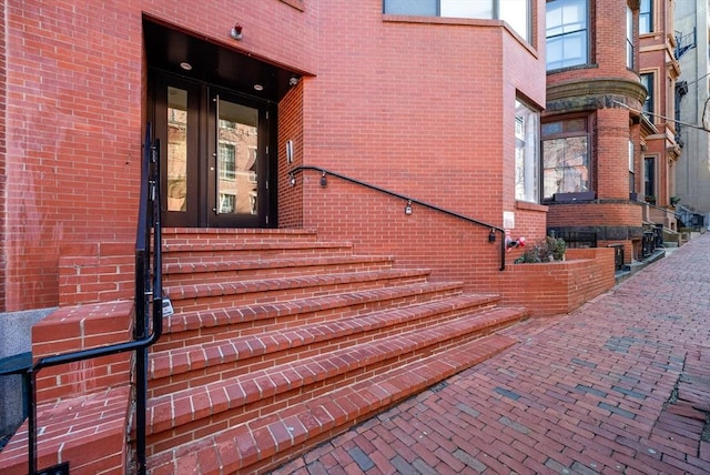 view of exterior entry with brick siding