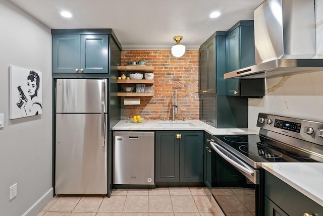 kitchen featuring a sink, light countertops, wall chimney range hood, and stainless steel appliances