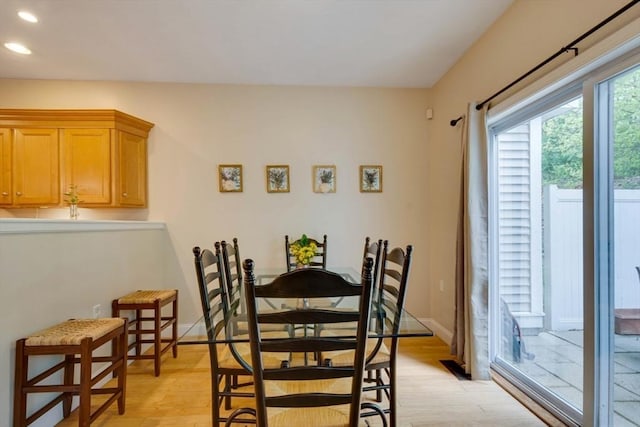 dining room featuring light wood-type flooring, recessed lighting, and baseboards