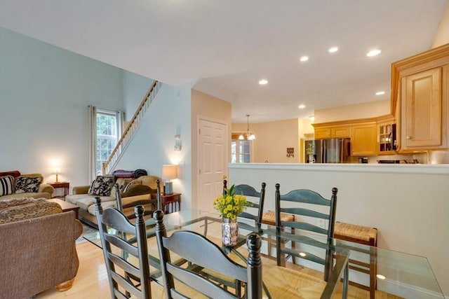 dining area with plenty of natural light, recessed lighting, light wood-style floors, and stairs