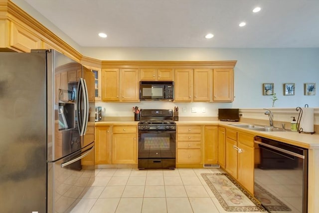 kitchen featuring black appliances, a sink, light tile patterned floors, recessed lighting, and light countertops