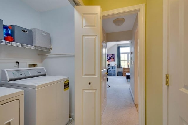 clothes washing area with washer and clothes dryer and light colored carpet