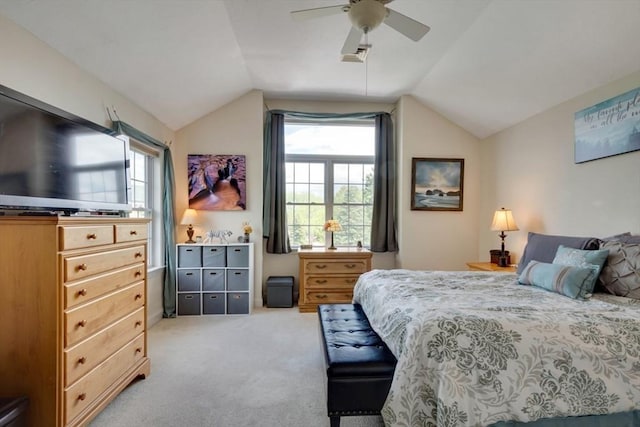 bedroom featuring light colored carpet, lofted ceiling, multiple windows, and ceiling fan