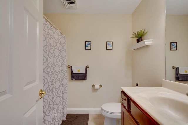 bathroom featuring vanity, toilet, tile patterned flooring, and baseboards