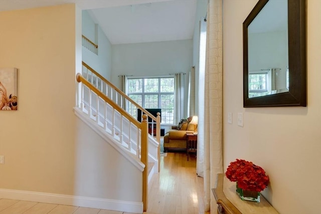 staircase with baseboards and wood finished floors