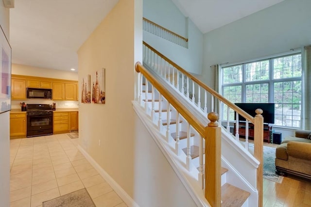 stairs with tile patterned flooring and vaulted ceiling