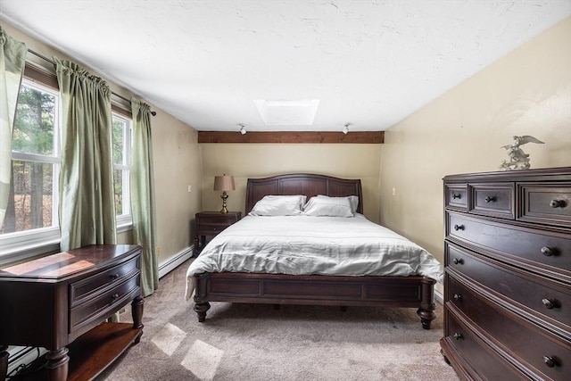 bedroom with a baseboard radiator, a skylight, and light colored carpet