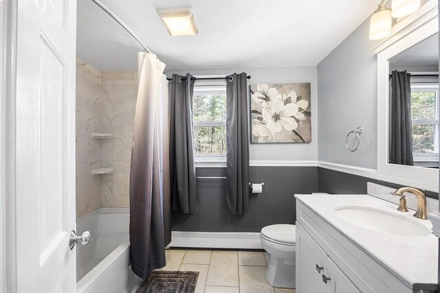 full bath with shower / tub combo with curtain, vanity, tile patterned floors, and toilet