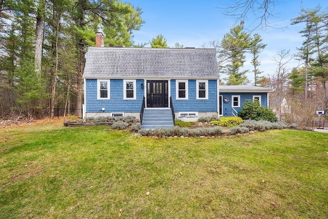 view of front of home featuring roof with shingles, a chimney, and a front yard