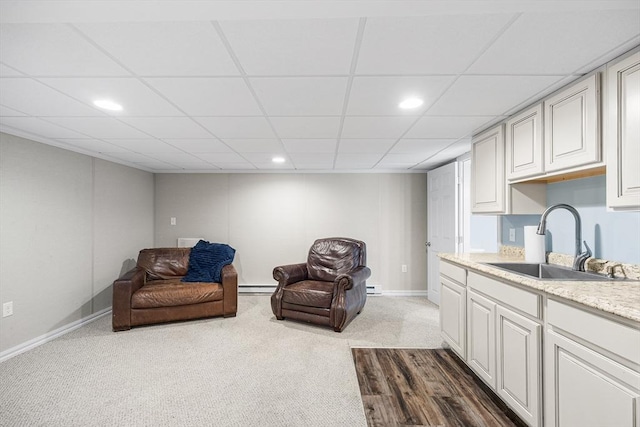 living area featuring baseboard heating, baseboards, carpet, and recessed lighting