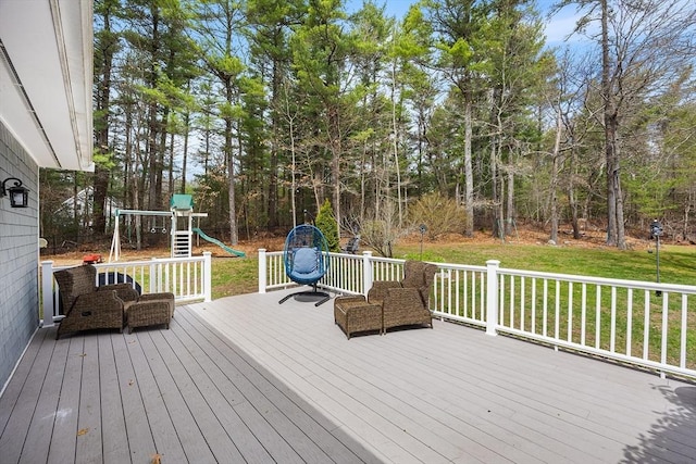 wooden deck with a yard and a playground