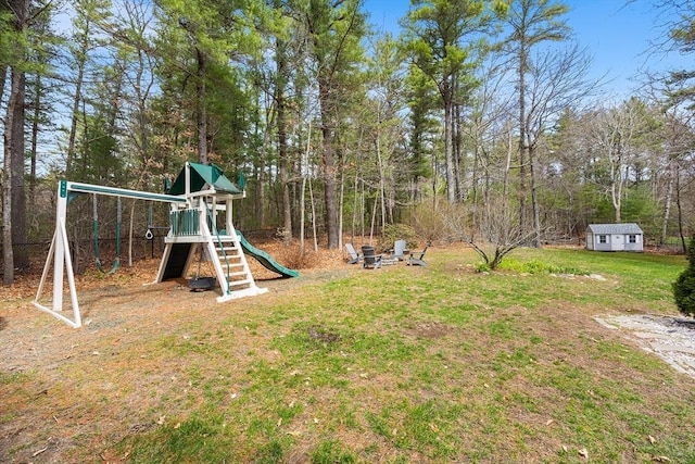 view of play area with a lawn and an outbuilding