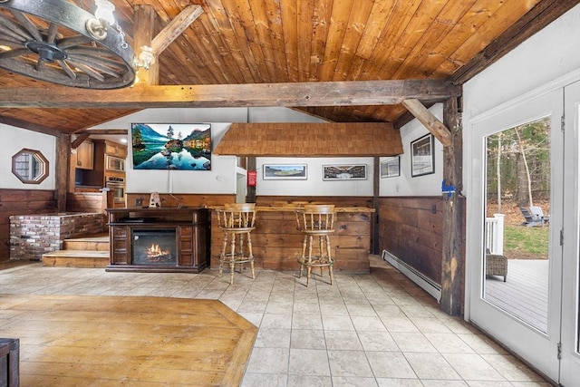 interior space featuring wooden walls, baseboard heating, and wooden ceiling